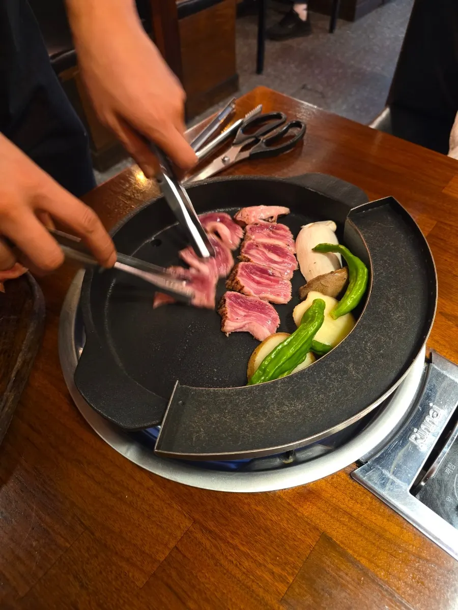 Woodae galbi placed on the grill