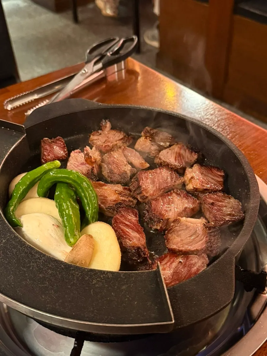 Staff grilling woodae galbi on the pan