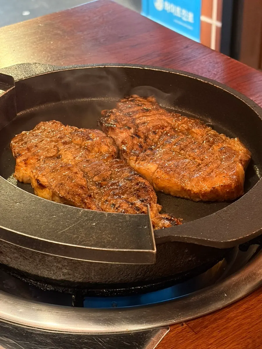 Dontan galbi being grilled on the barbecue