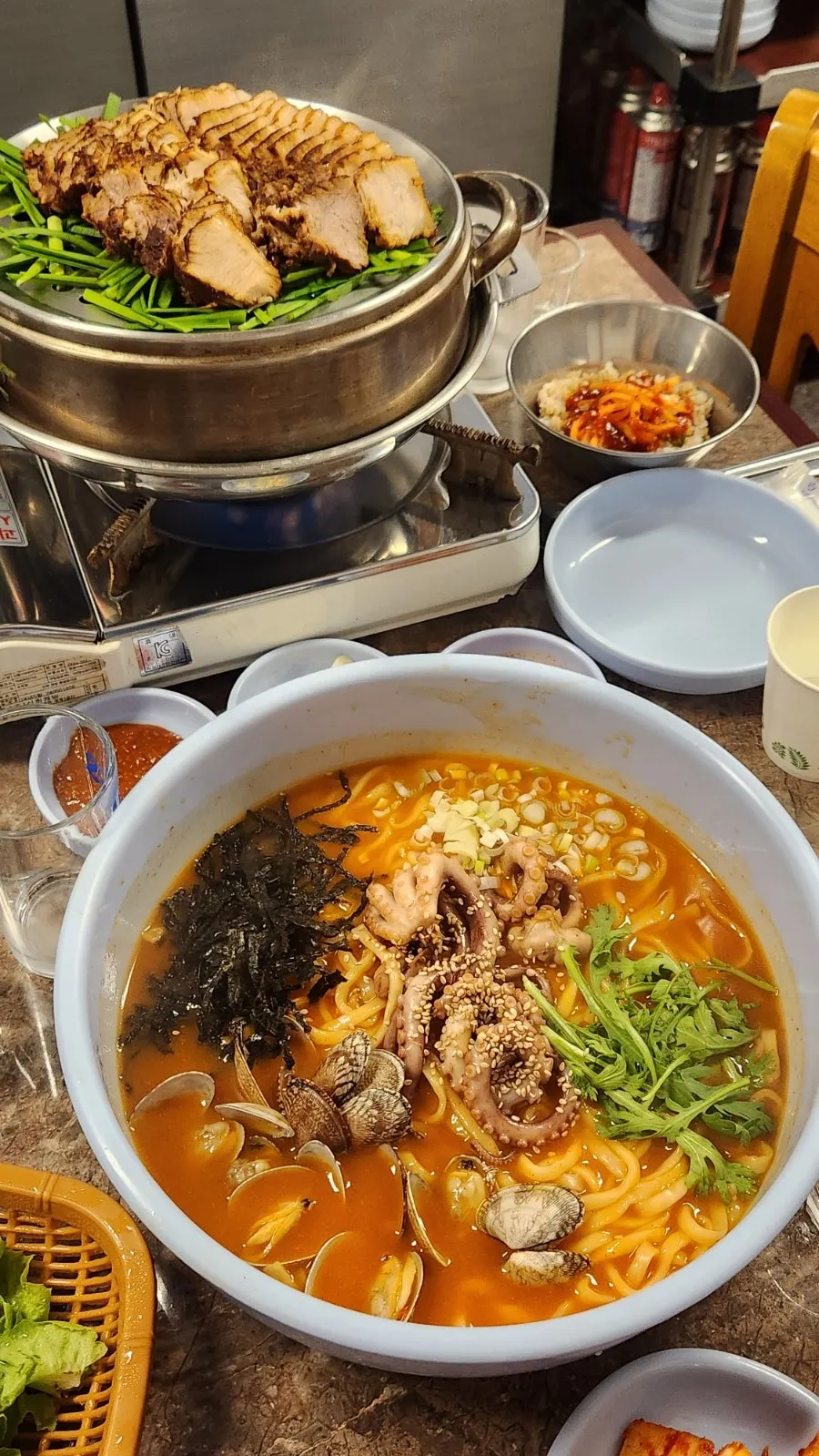 Two servings of kalnakji topped with whole octopus