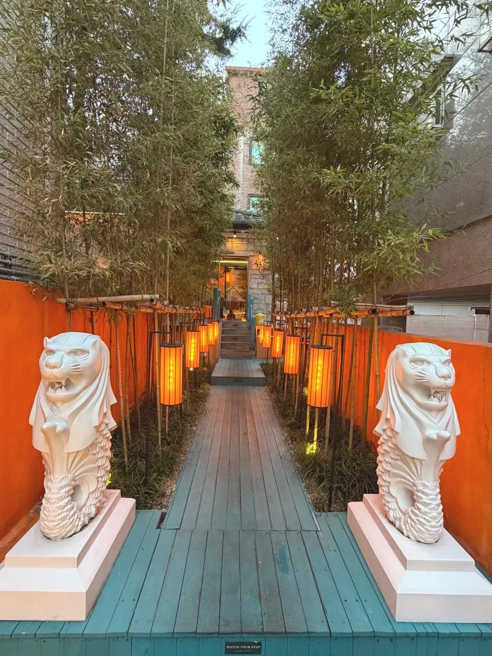 Merlion statues and bamboo lantern path at the entrance