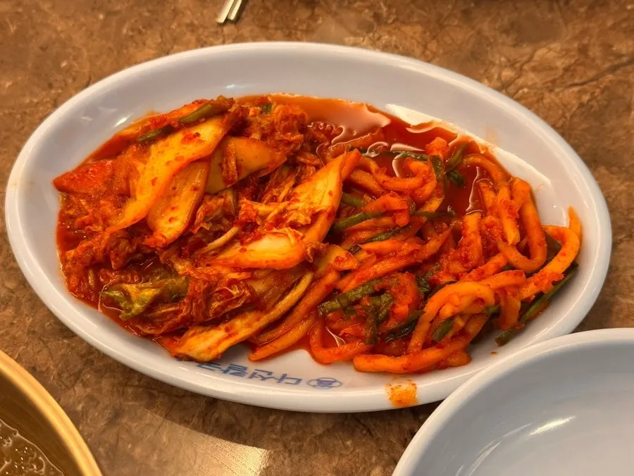 Plate of kimchi and banchan at Daseon Kalguksu