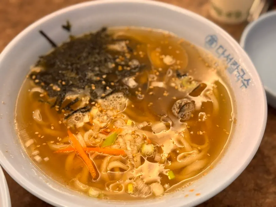 Three noodle dishes lined up on one table