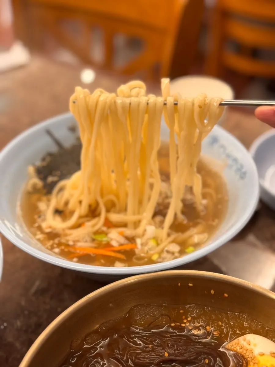 Deep-colored broth of jang kalguksu