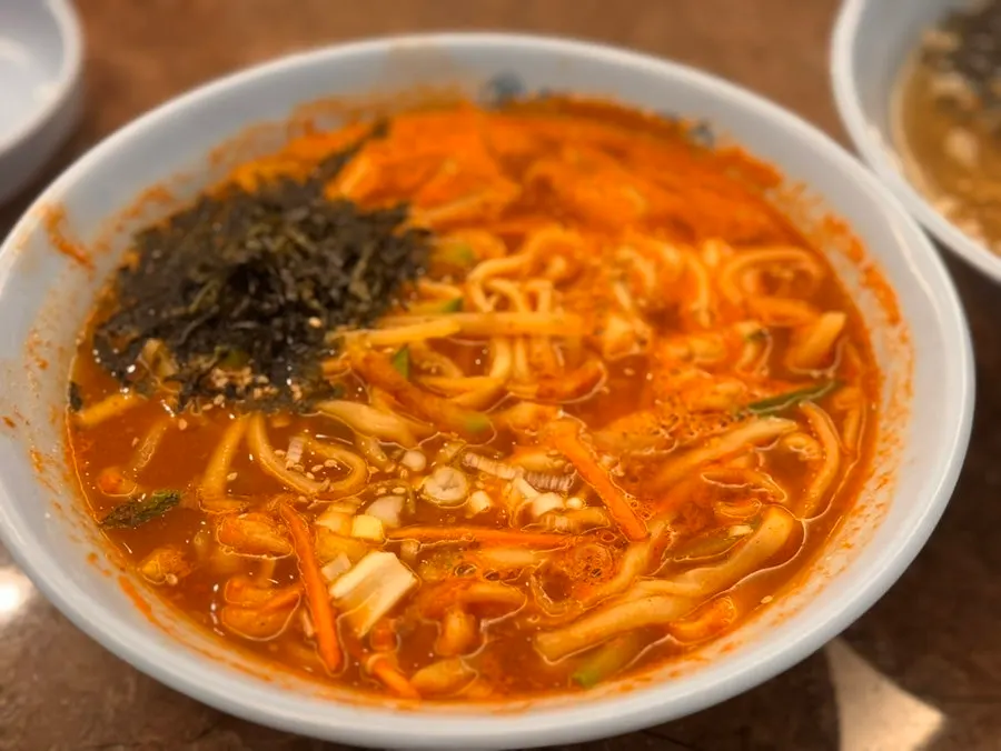 A spoonful of the soybean-paste-based jang kalguksu broth