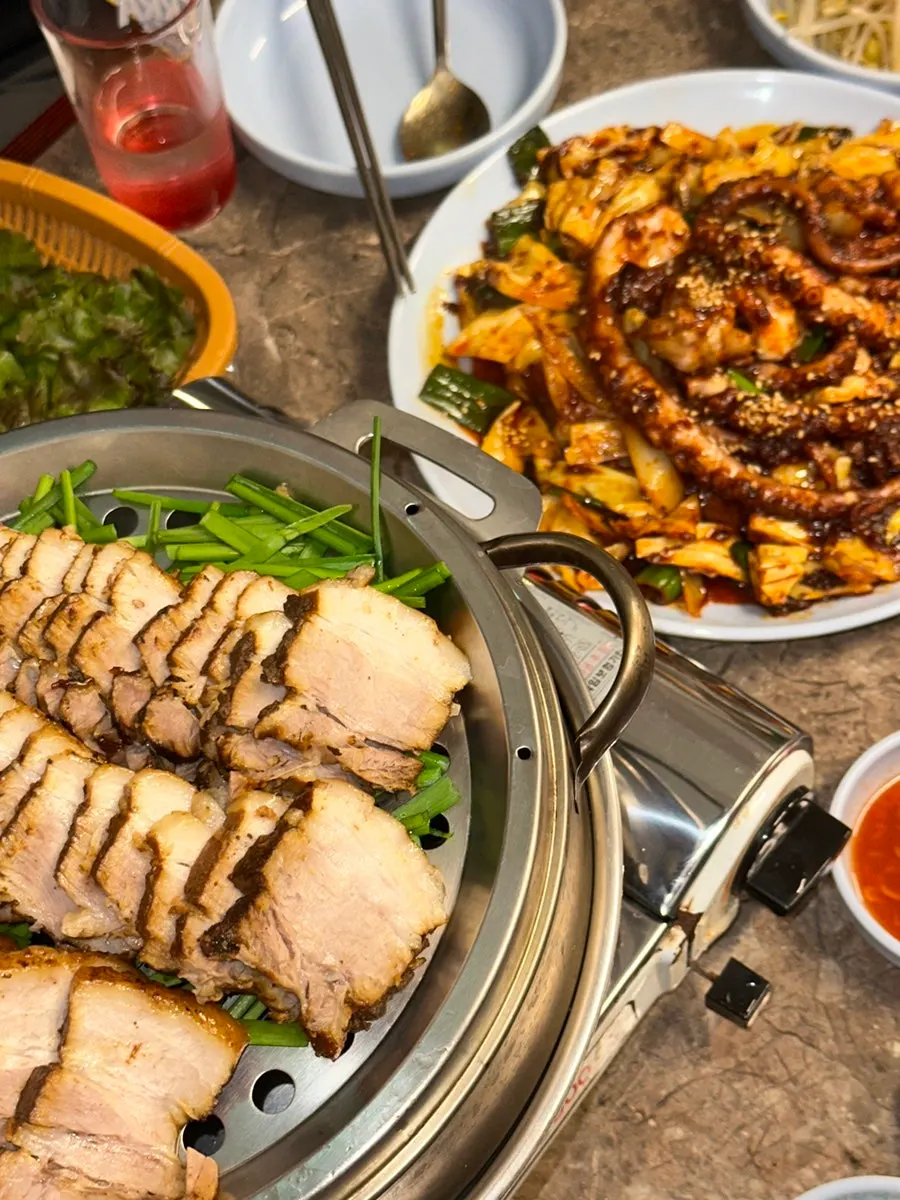 Table set with both suyuk-bossam and spicy stir-fried octopus