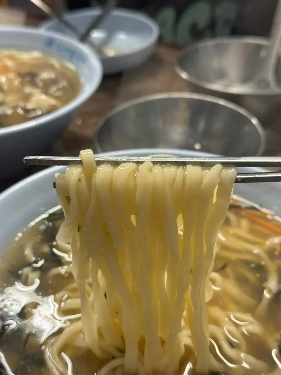 Lifting a strand of cham-daseon kalguksu noodles