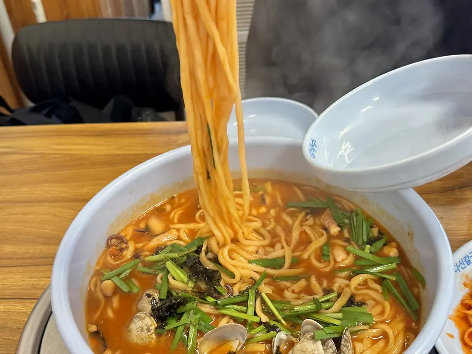 Scooping up a spoonful of kal-nakji broth