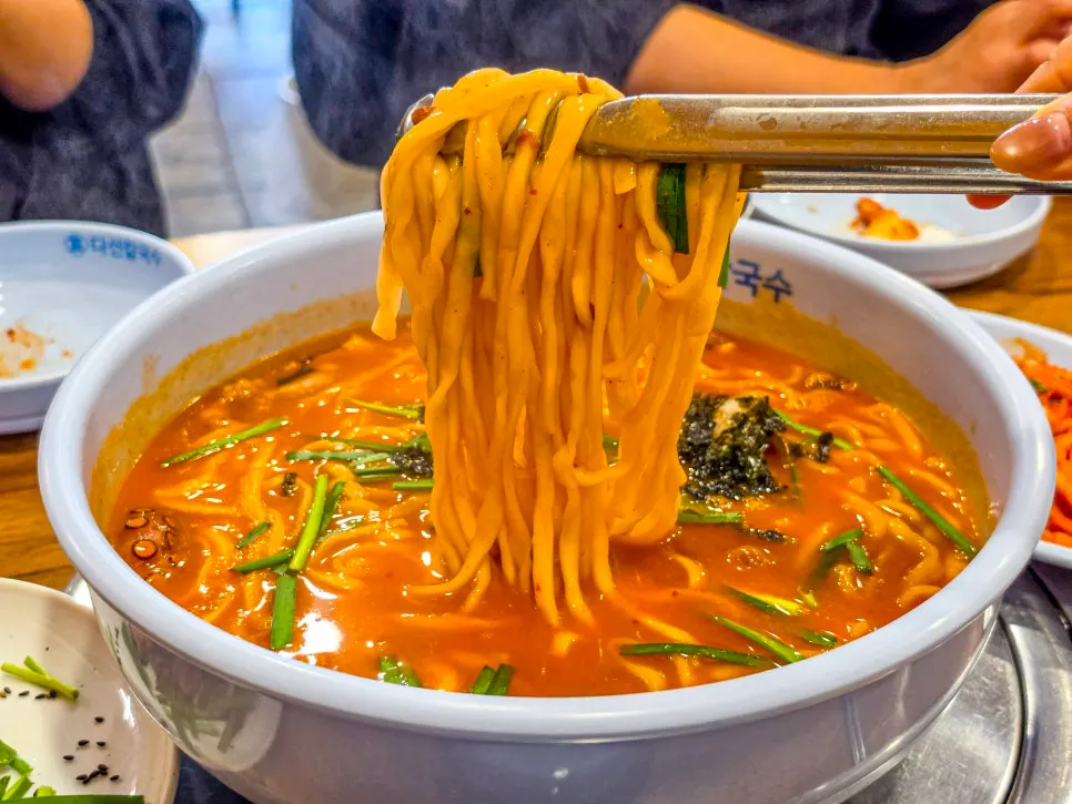Chewy kalguksu noodles lifted from the bowl