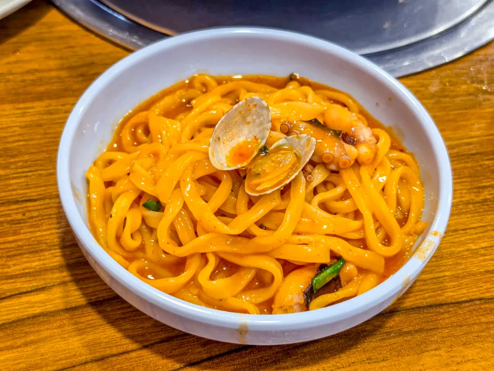A plate of kalguksu scooped out to eat with boiled pork