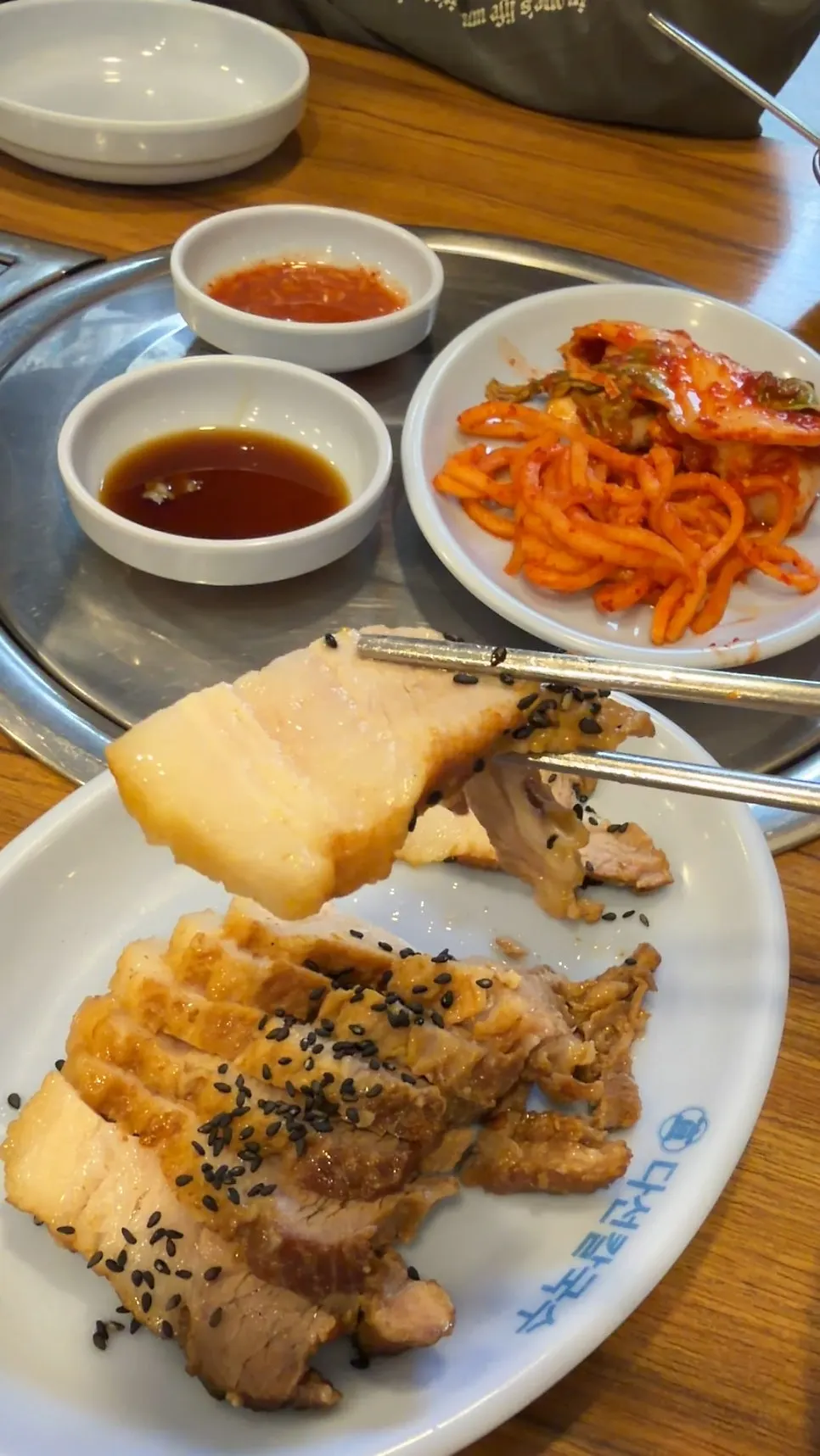 A piece of boiled pork picked up with chopsticks