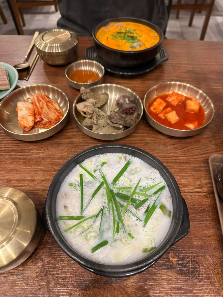 Table set with sundaeguk, spicy sundaeguk, and pyeonyuk