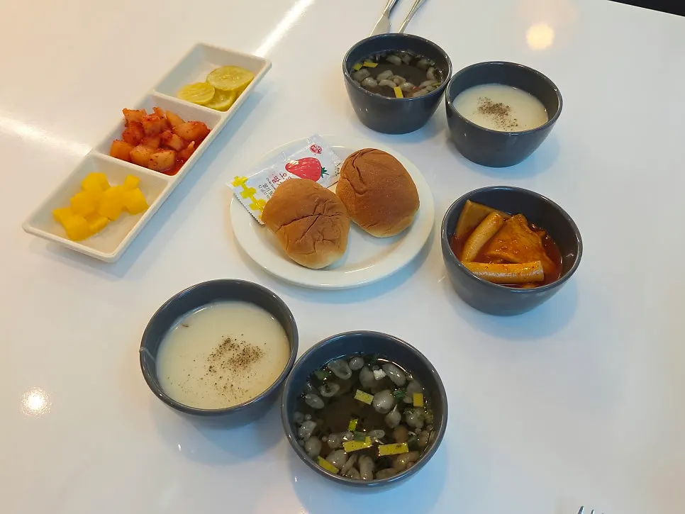 Table filled with soup and side dishes brought from the self-bar