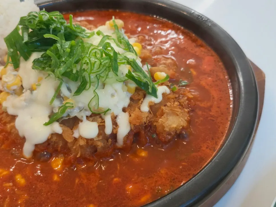 Hot pot cutlet sitting in spicy seasoned broth