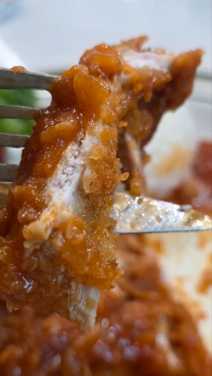 A piece of pork cutlet dipped in sauce
