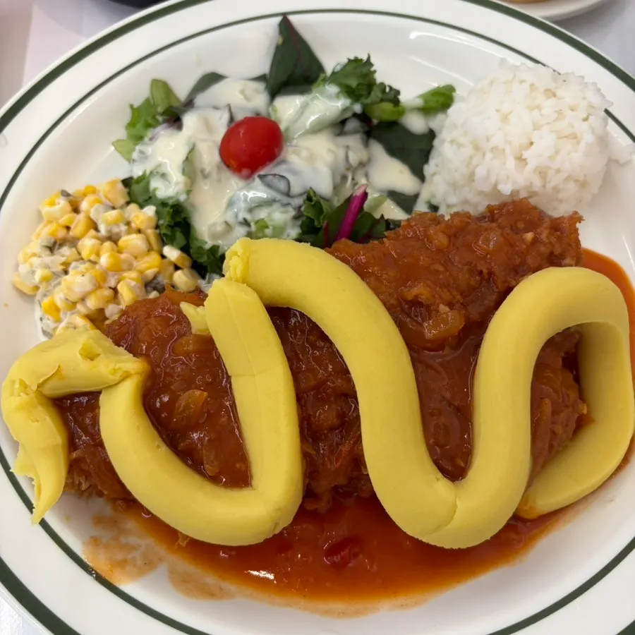 Close-up of cheese cutlet topped with sweet potato mousse