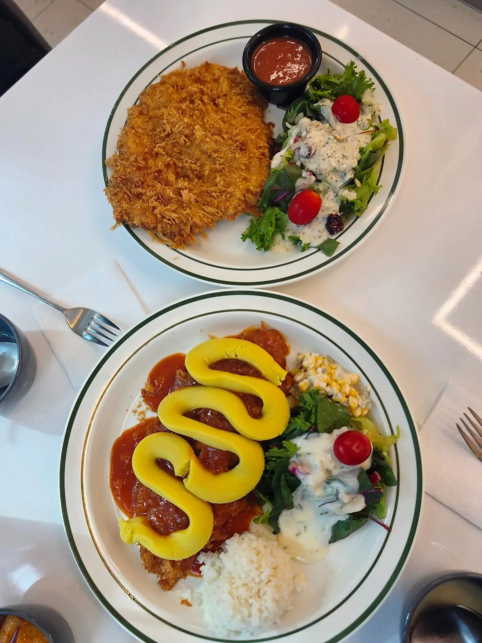 Full shot of the large whole grain salad pork cutlet