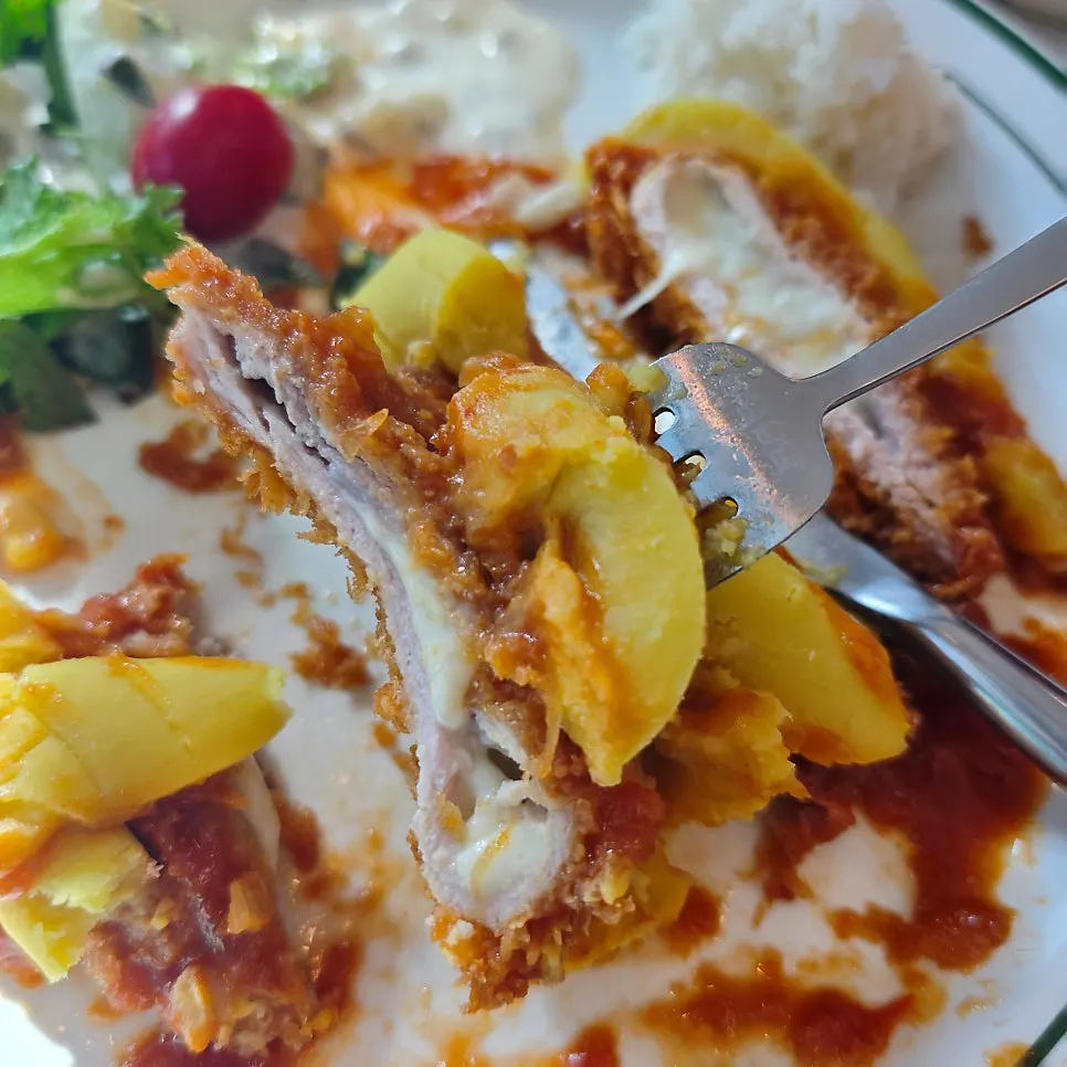 A bite of sweet potato cheese cutlet with salad