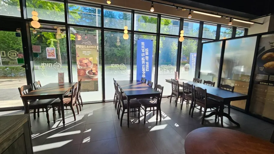 Interior of the Tteokmama store with bulb lighting and wood-tone decor