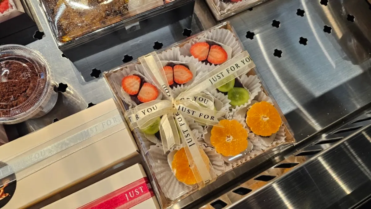 Refrigerated showcase of fruit chapssaltteok with strawberries and shine muscat grapes