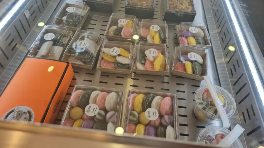 Display of mini bite-sized rice cakes, fish-shaped jeolpyeon, and tricolor dutteok