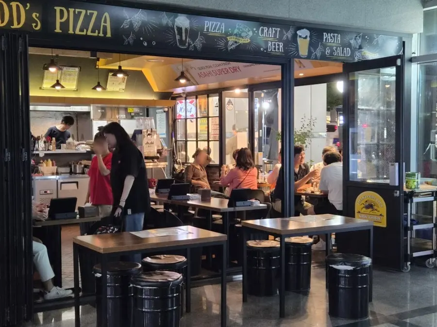Outdoor patio-style seating in the main building of Didi's Pizza Pub