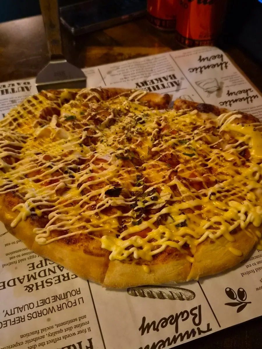 Slice of pizza topped with pepperoni, onion and mushroom