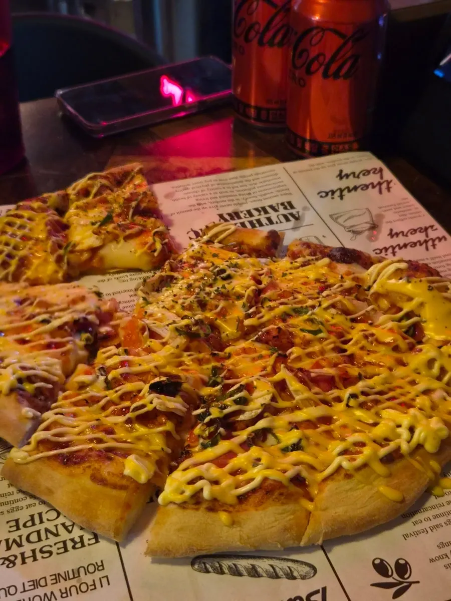 Lifting a slice of the handmade-dough pizza