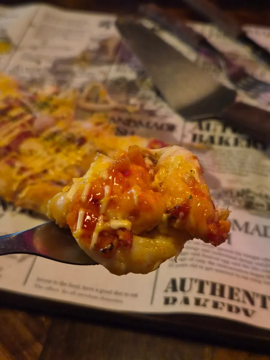 Handmade-dough Didi's Buldak Pizza piled with chicken