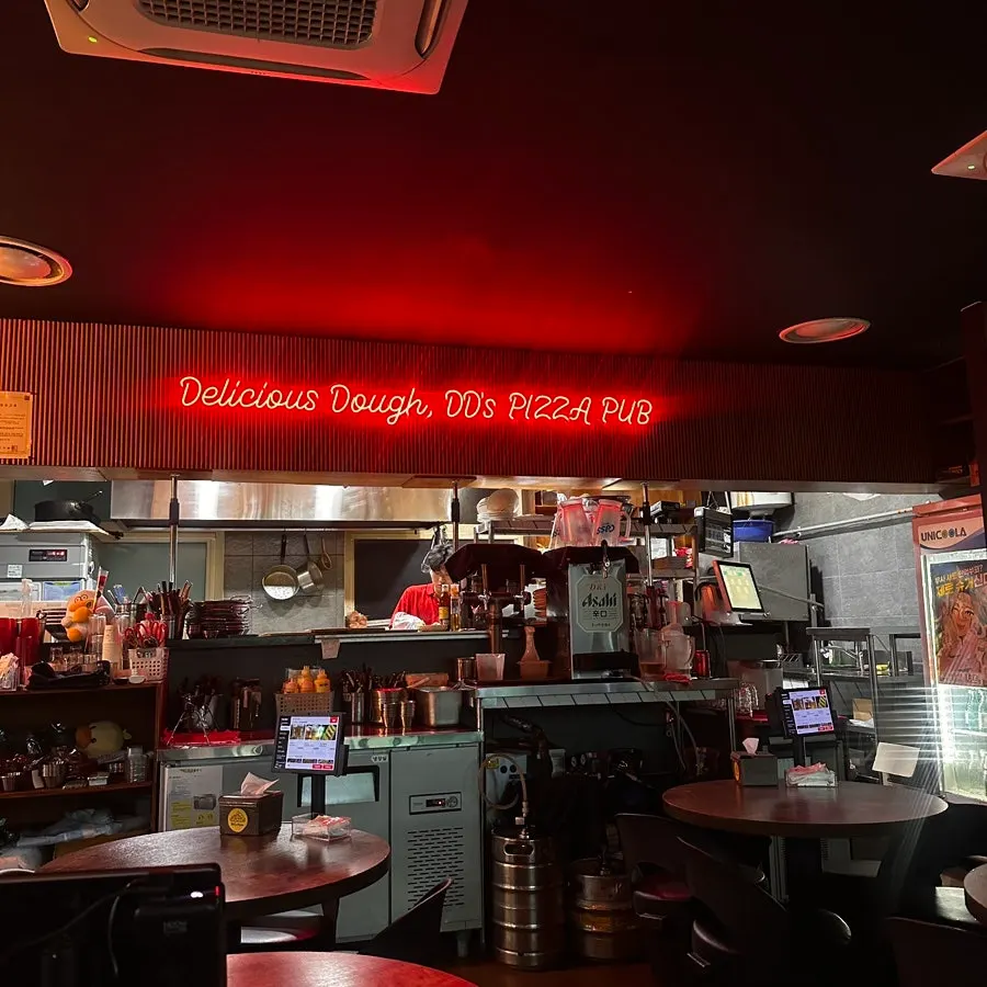 Indoor seating split across two storefronts at Didi's Pizza Pub