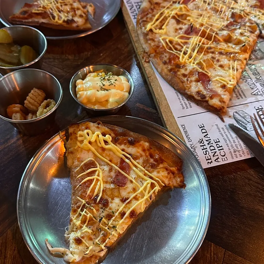 A slice of pizza dipped in the garlic sauce