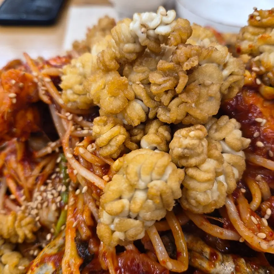 Monkfish flesh, bean sprouts, and sea pineapple visible in the agujjim
