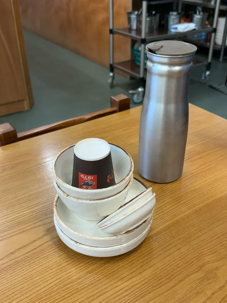 Table setting with small plate, water bottle, and wet wipes