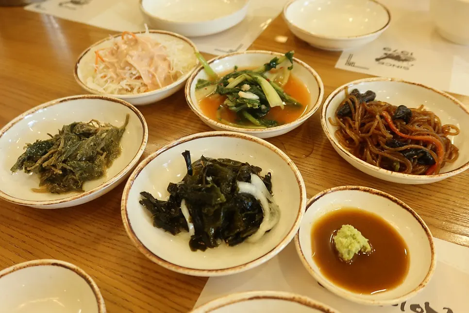 Side dish spread served with the raw monkfish sujeuk