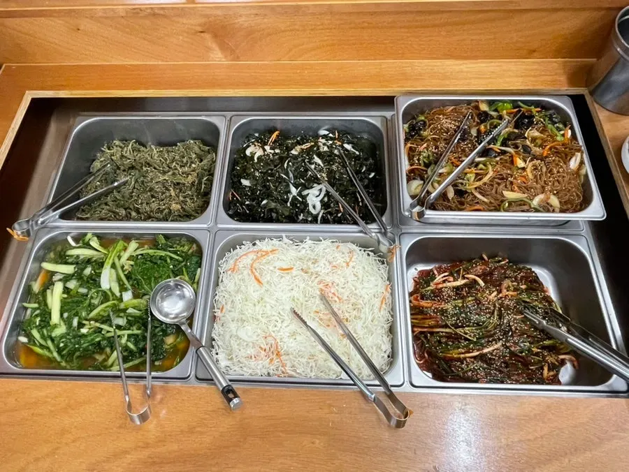 Self-serve side dish bar filled with food