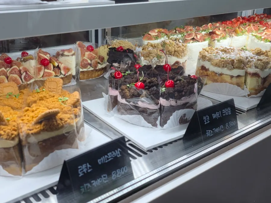 Various cake slices displayed in the showcase