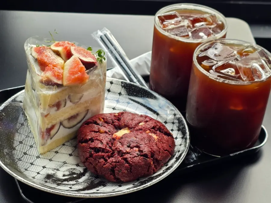 Cake, cookie and americano on the table