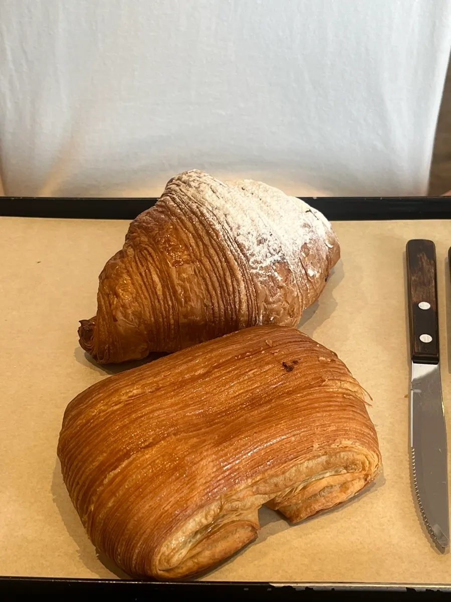 Plate with cream croissant and pain au chocolat noisette