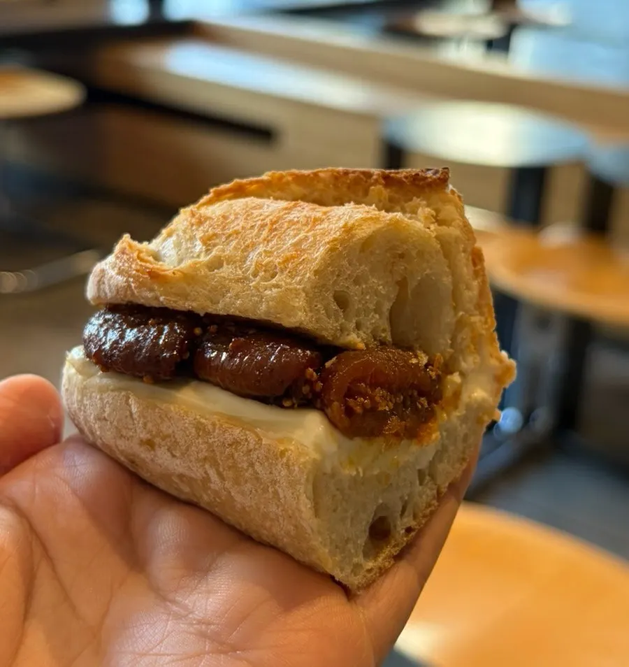 Close-up of a piece of fig cream cheese baguette