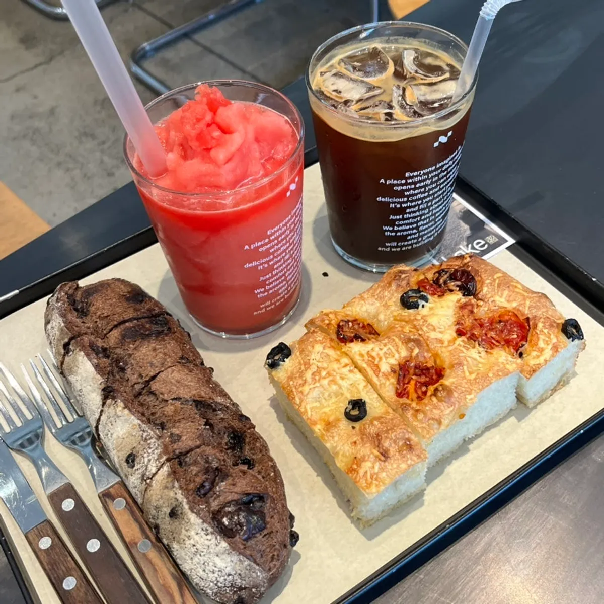 Watermelon juice, chocolate baguette, and focaccia table spread at Degree Gojan Branch