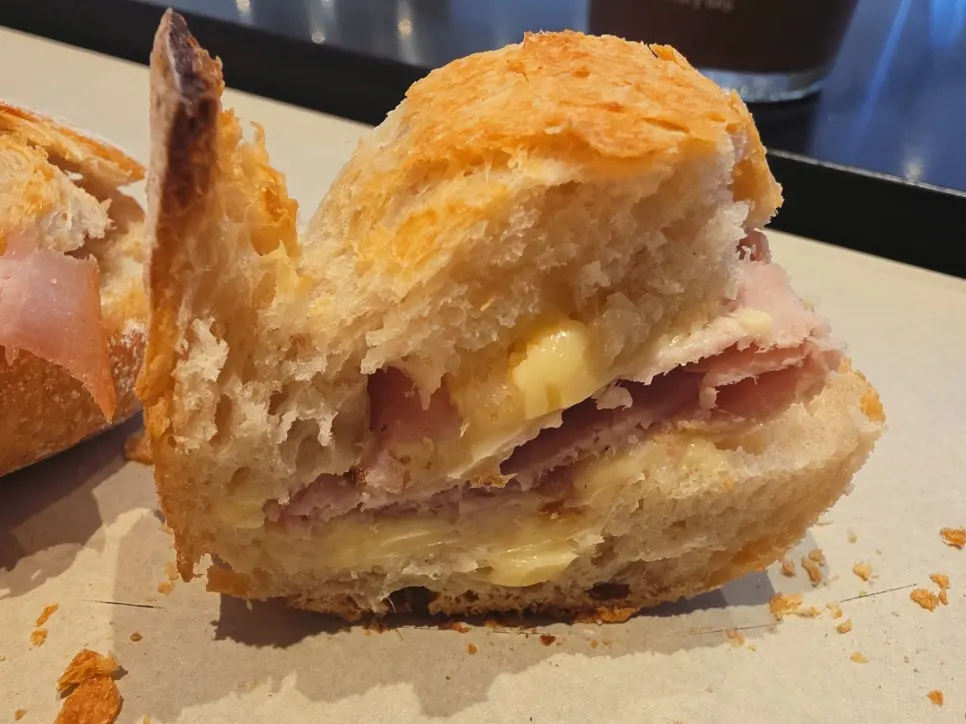 Cross-section of a baguette filled with ham and butter