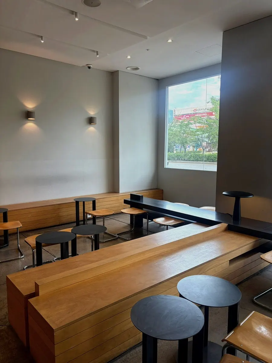 Interior of Degree Gojan Branch decorated in black and wood tones