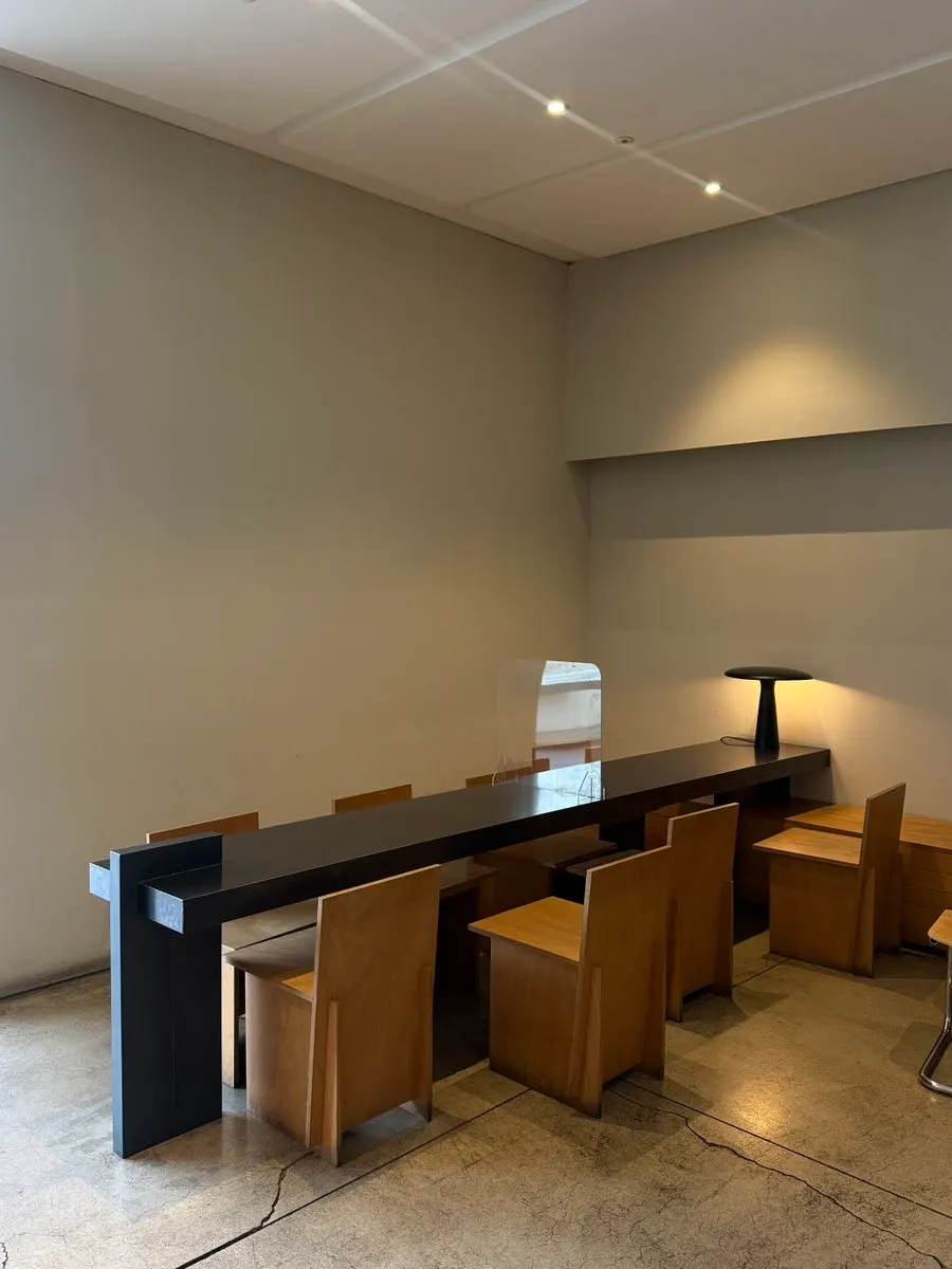 Café seating with an open view through the floor-to-ceiling windows
