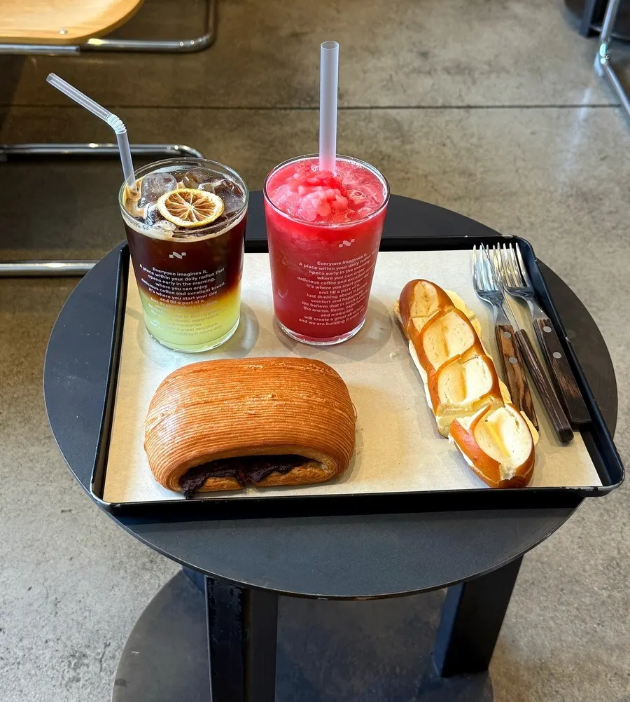 Lemon Americano, watermelon juice, pain au hazelnut chocolat, and butter pretzel