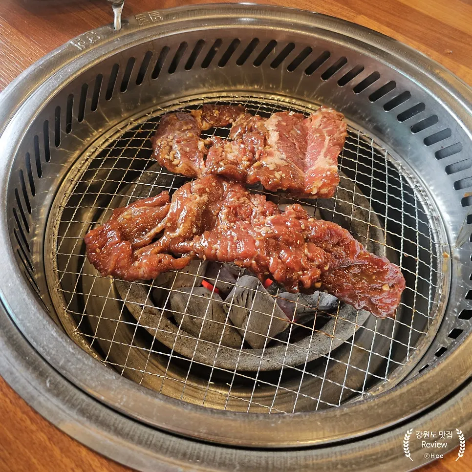 Pork galbi cooking on the grill