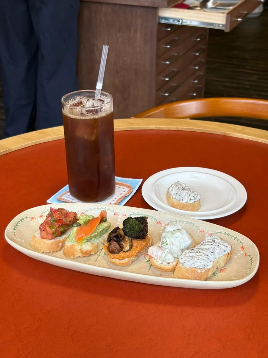 Five varieties of bite-size open sandwiches on a plate