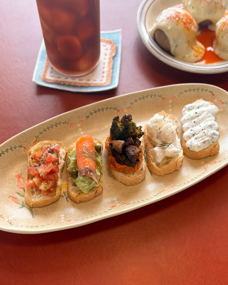 Five bite-size open sandwiches on one plate