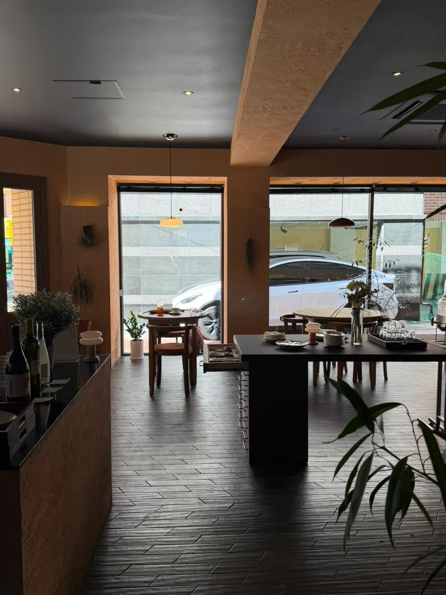 Dento's interior with a view outside through the floor-to-ceiling windows
