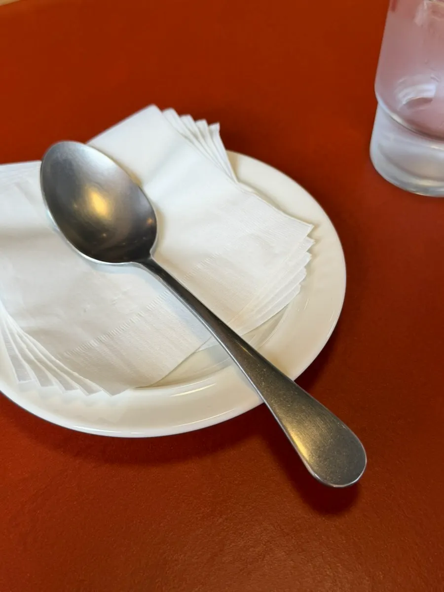 A table set with cutlery collected from the self-serve bar