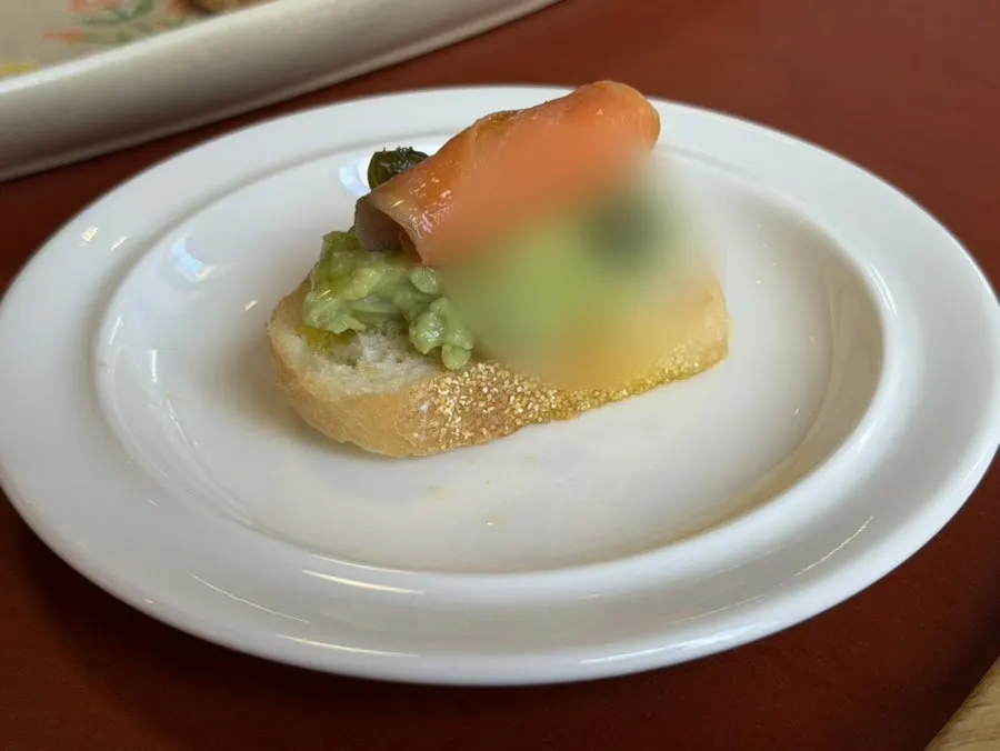 Open sandwich topped with smoked salmon and avocado